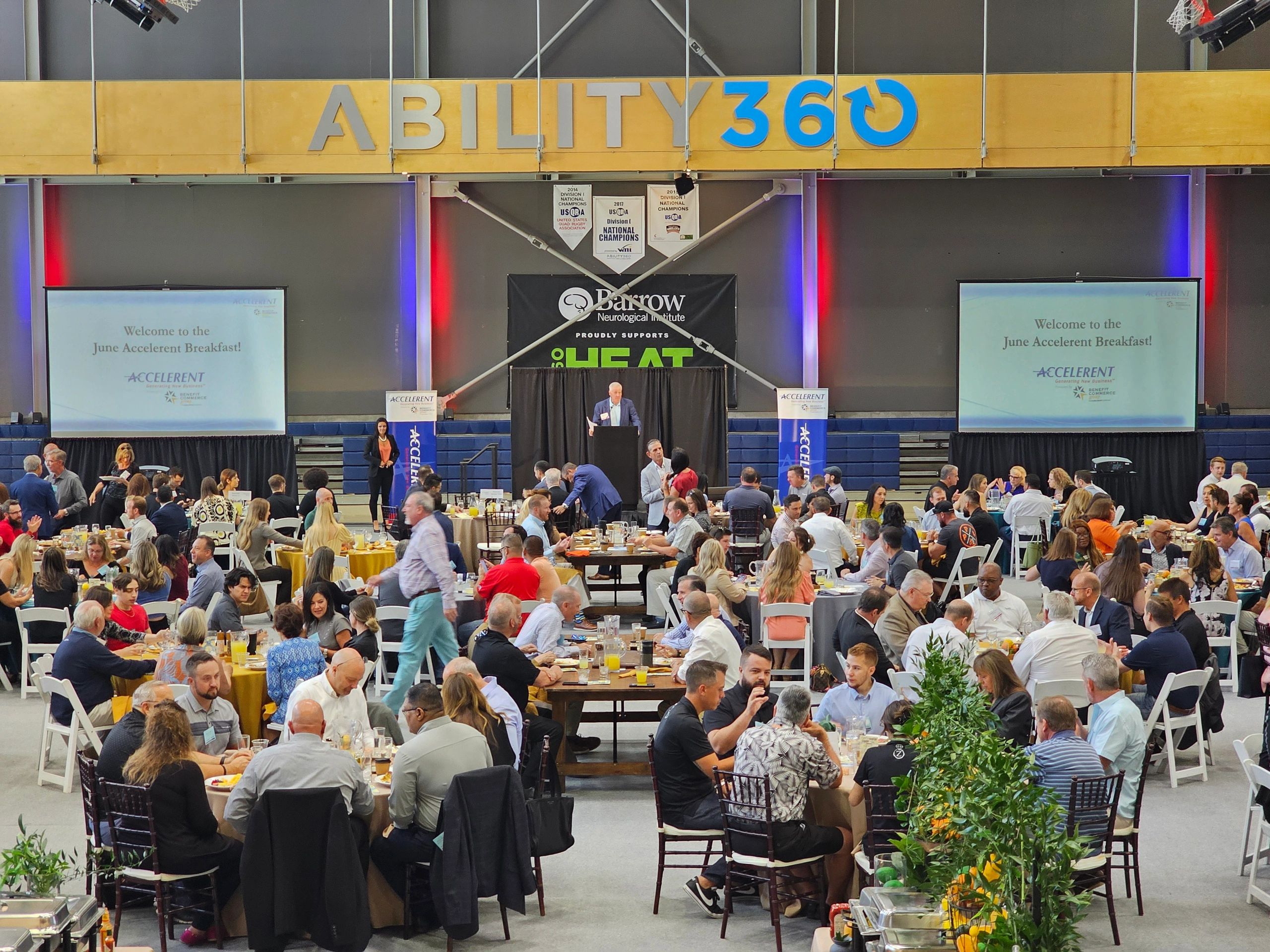 Large indoor event venue with stage and projection screens