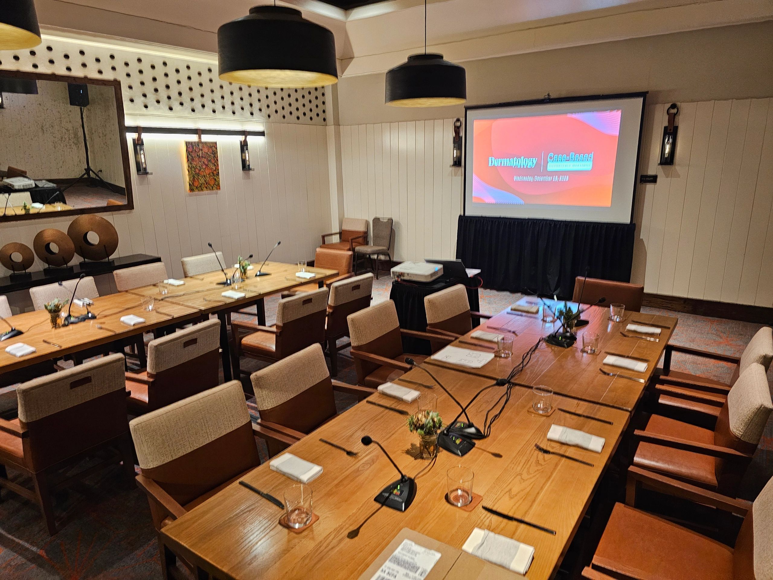 Conference room U-shape tables with microphones and presentation